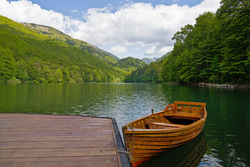 Serene wooden boat docked at tranquil Biogradska Lake © Darkdriver