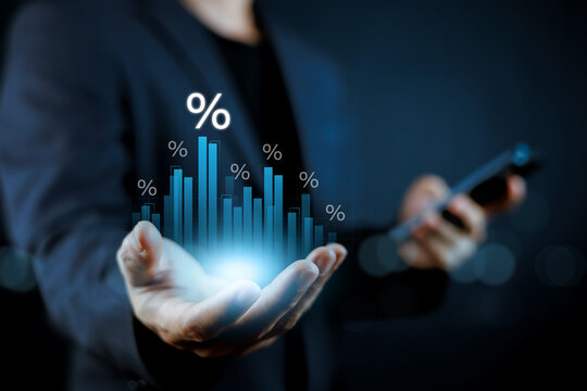 Businessman holding virtual hologram of financial bar chart with percentage signs. Concept of interest rate analysis, business growth, economic market trends, and investment management strategy.