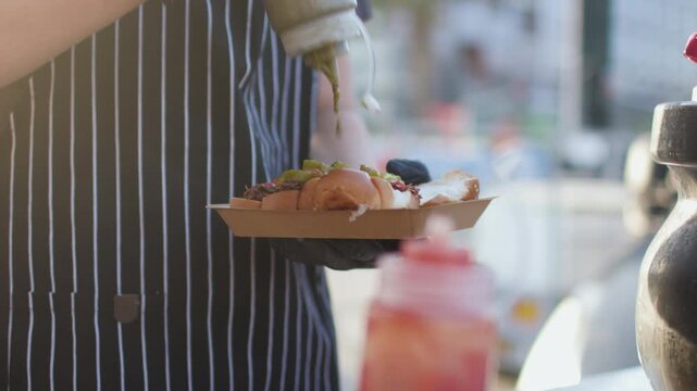 A cook prepares food at an outdoor food court. Street food at food festivals in Israel; a celebration in Haifa. Close-up of street food.