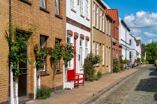 Friedrichstadt, Germany - Picturesque old town street with historic houses and flowering roses in Schleswig-Holstein