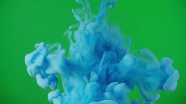 Blue ink cloud blooming in clear water during slow motion against green screen background