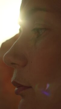 Woman face sunset close up profile of a female person outdoors at golden hour creating a dreamy and peaceful atmosphere