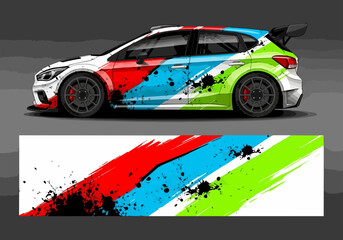Fototapeta premium Colorful rally car with dynamic paint splatter design wrap