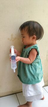 Adorable one year old toddler exploring the house surroundings completely alone