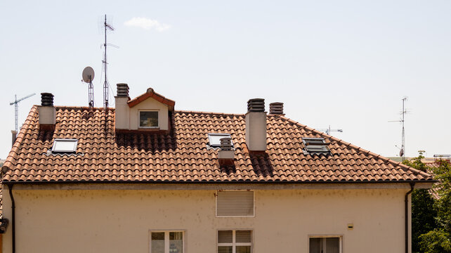 Tejado de edificio residencial con chimenea ventana y antena