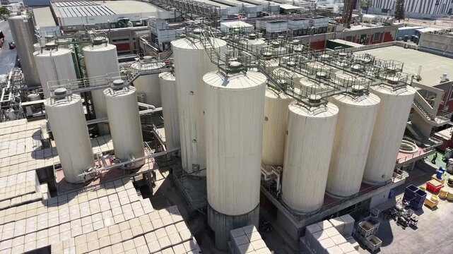 Industrial beer brewing tanks and stainless steel fermentation vessels in a modern brewery production facility