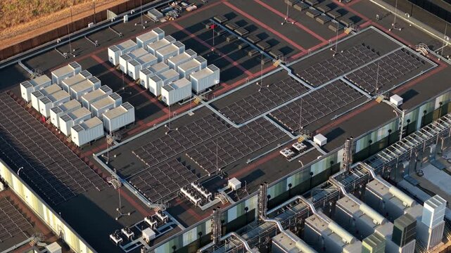 Aerial View of Hyperscale Data Center Rooftop with Cooling Units, Air Handlers and Solar Panels for AI Tech
