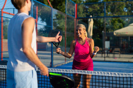 Couple playing padel with thumbs up gesture
