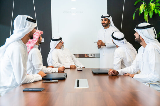 Group of corporate arab businessmen meeting in the office - Saudi and emirati business men meet for a business deal 