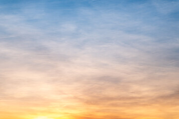 Obraz premium Sky sunset,Beautiful sunrise sky with vibrant gradient orange and gold colors and soft blue, Clear atmosphere with wispy clouds. Peaceful, perfect for background and copy space, High resolution images