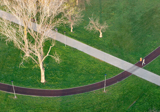 Aerial view of Usce Park with winding paths, lush green grass, and bare trees in Belgrade, City of Belgrade, Serbia.