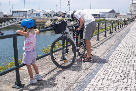  Adjusting an Electric Bicycle on a Wooden Boardwalk Near the Sea