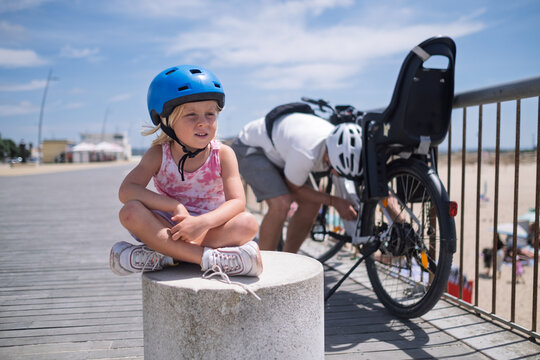  Adjusting an Electric Bicycle on a Wooden Boardwalk Near the Sea