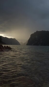 Ratchaprapha Dam in the morning featuring sunlight and mist amidst khao sok national park in surat thani province thailand where towering limestone cliffs rise from the freshwater reservoir.