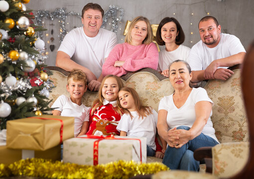 Family with children on sofa in christmas interior