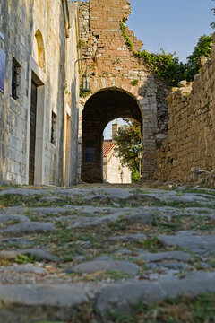 Old stone archway in Stari Bar, Montenegro, historic village street view.