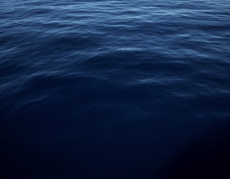 Deep navy blue ocean water texture background template with calm waves