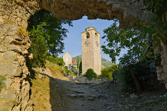 Ancient stone tower ruins in Stari Bar Montenegro framed by historic archway