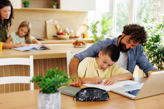 Family members learning and studying at home, with parents helping their children with homework and online lessons, creating a supportive educational environment