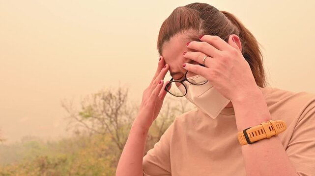 Footage of Asian woman while cough and having headache becaused of by Bad air pollution (PM2.5). PM2.5 levels meaning the air quality posed a health hazard.