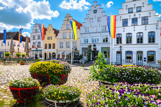 Historic gabled houses and colorful flower displays on the market square of Friedrichstadt, Schleswig-Holstein.