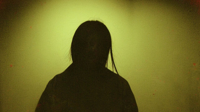 Dark Long Haired Figure Emerging from Green Light in Vintage Japanese Horror Scene