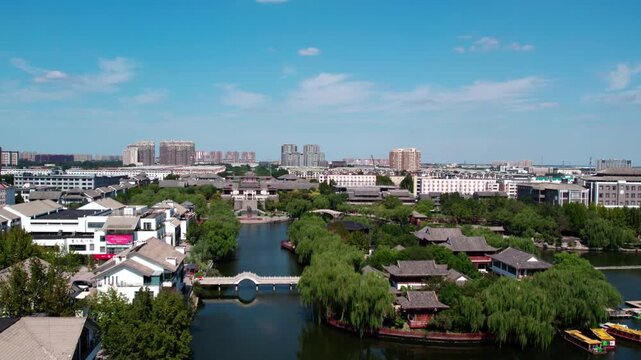 A scenic water town with traditional architecture, willow trees, and bridges under a bright blue sky, blending nature and urban elements.