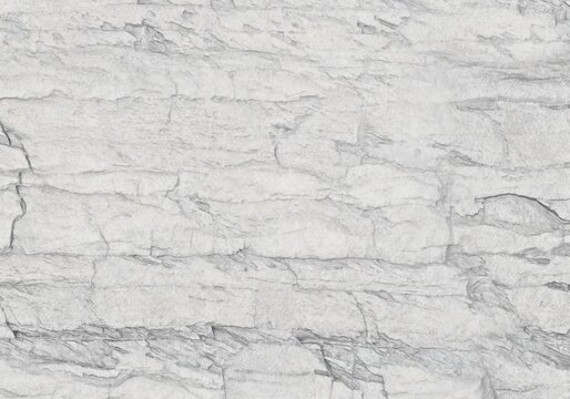 Layered white stone rock texture background, natural rough slate surface for product backdrop.