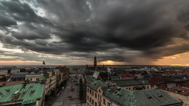 Storm Clouds Rolling Over Helsingborg Town Hall and Rooftops at Sunset