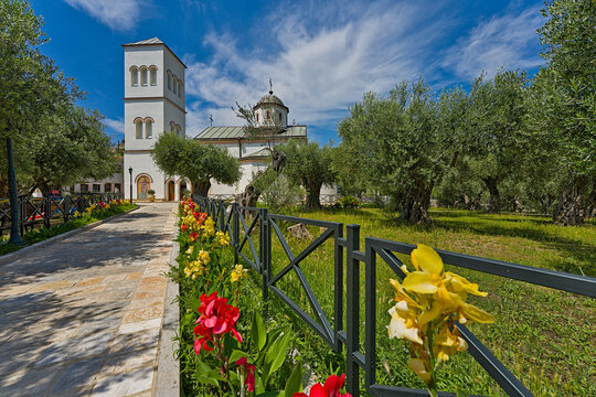 St. Nicholas Church in Ulcinj, Montenegro, with olive trees and colorful flowers