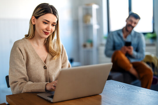 Remote work and digital business. Diverse couple collaborating online, managing projects with laptop