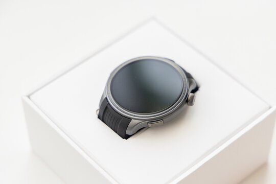 Sleek Dark Smartwatch Displayed Neatly Inside Its White Retail Box