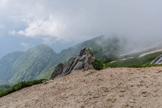 Weathered granite rock outcrop on misty mountain ridge, Japan