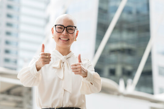 Happy smiling Asian woman with confident in city wear work clothes, show hands standing outdoor at work with modern office business building background