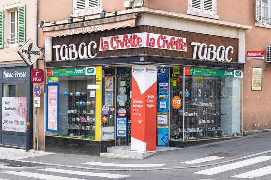 Macon, France - 01 August 2026 - Exterior view of La Civette tobacco and press shop on a street corner displaying signs, lottery notices, and lottery services.