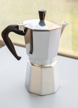 Classic Silver Moka Pot for Brewing Coffee on a Bright Background