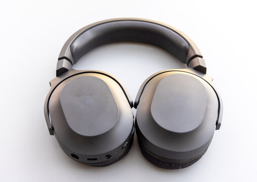 Close up of black wireless overear headphones on a white background