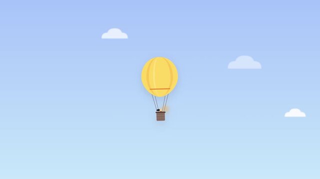 Yellow hot air balloon drifting in a clear blue sky