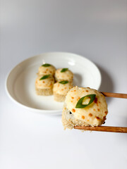 Beautifully arranged assorted sushi on a white plate © Polina_mrtnk