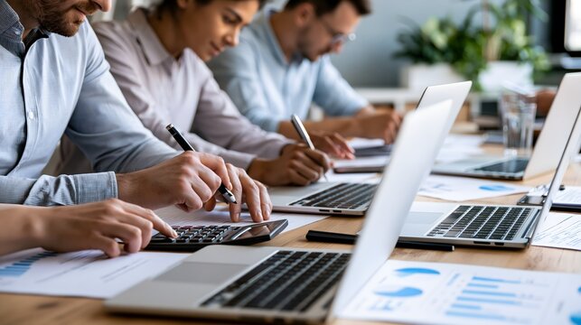 fourth quarter budget planning, adult finance professionals calculating business expenses, cash flow and annual budgets around a conference table, laptops, financial reports and charts, modern