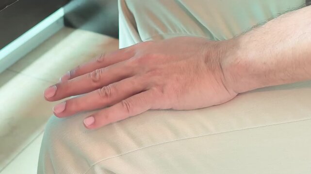 elderly asian man hand with unilateral parkinsonian tremor, parkinson's disease on one side during single side early stage of neurological disorder symptom