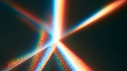 Naklejka premium Captivating light spectrum refraction creating vibrant rainbow beams across a dark, textured background.