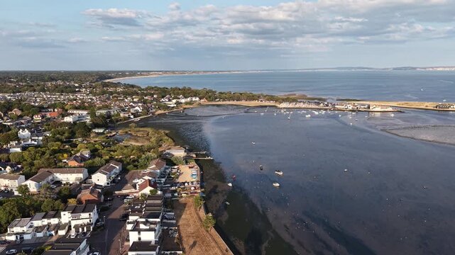 Aerial drone footage of calm blue sea, coastal trail and lush vegetation in warm golden-hour light. Peaceful cinematic seascape, ideal for travel, tourism and nature projects.