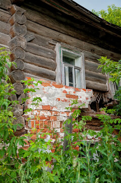 Weathered wooden house with brickwork