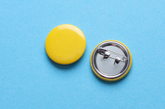Yellow blank round pin button badge on blue background. Mockup template