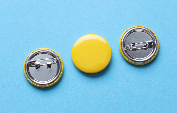 Yellow blank round pin button badge on blue background. Mockup template