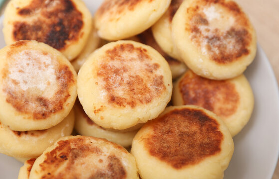 Homemade delicious syrniki, cheese pancakes in a plate on the table