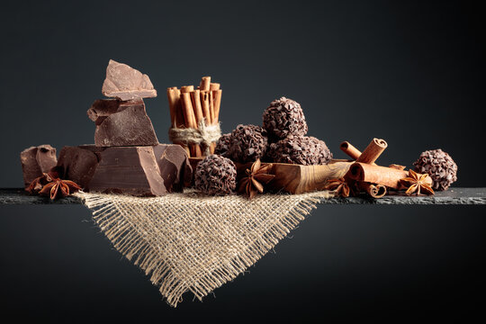 Chocolate truffles with broken pieces of chocolate and spices.