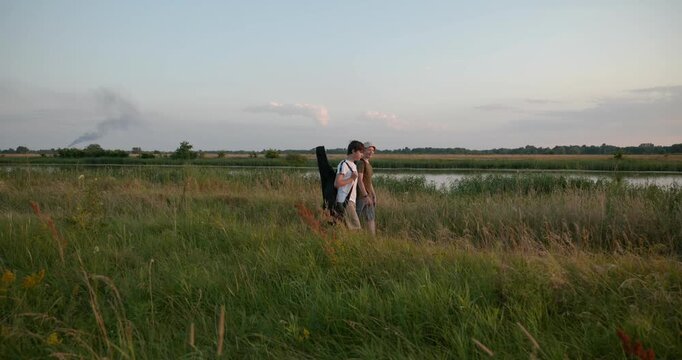 Two friends boys hike walking on nature. Teenagers spending time together. 4K 10-bit