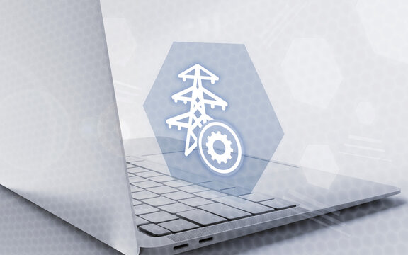 Laptop with virtual interface showing electricity pylon and gear icon, representing energy management, power grid settings, and industrial infrastructure technology